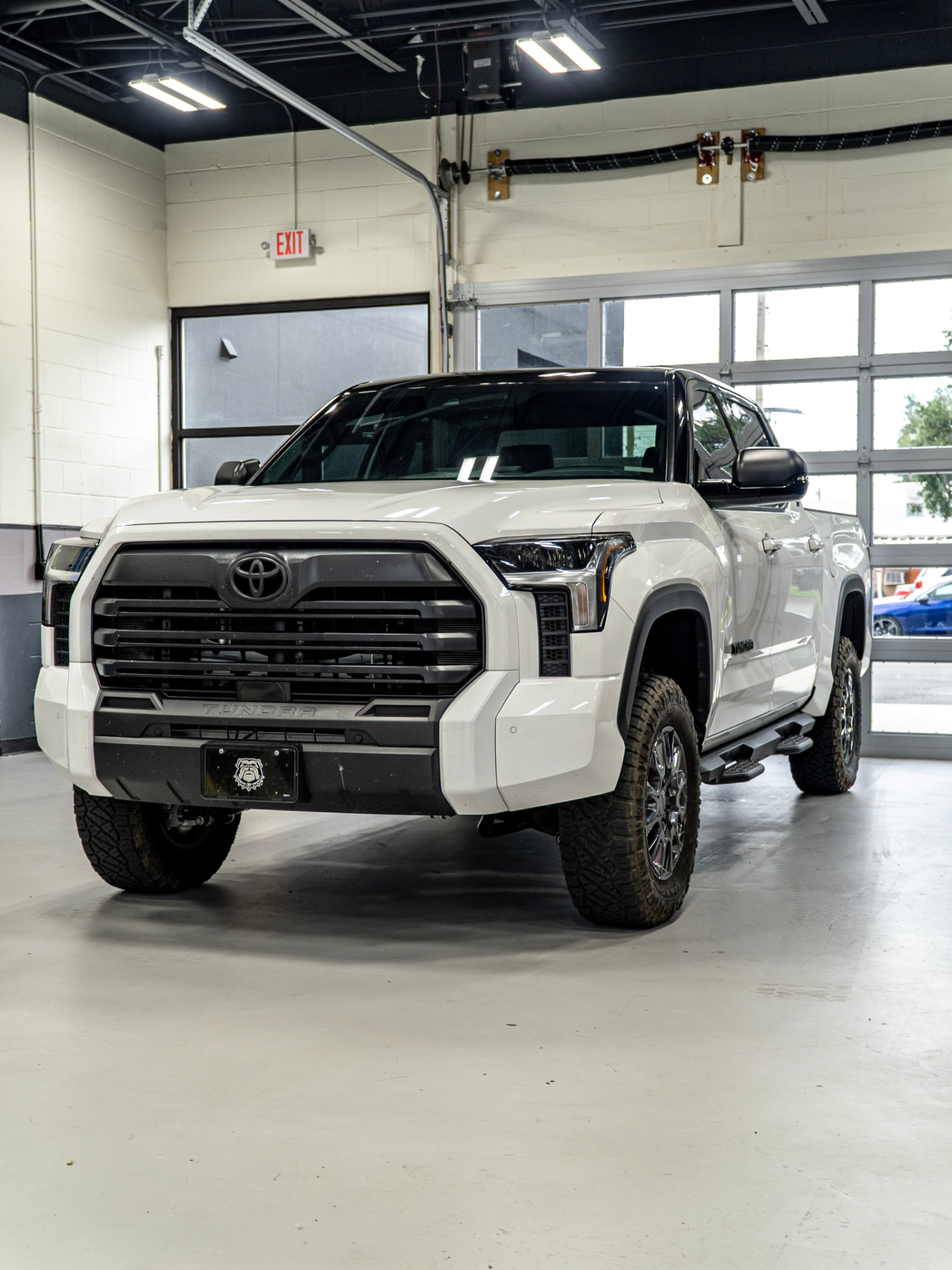 White Toyota Tundra with paint protection film finished in the FILMHAUS install bay