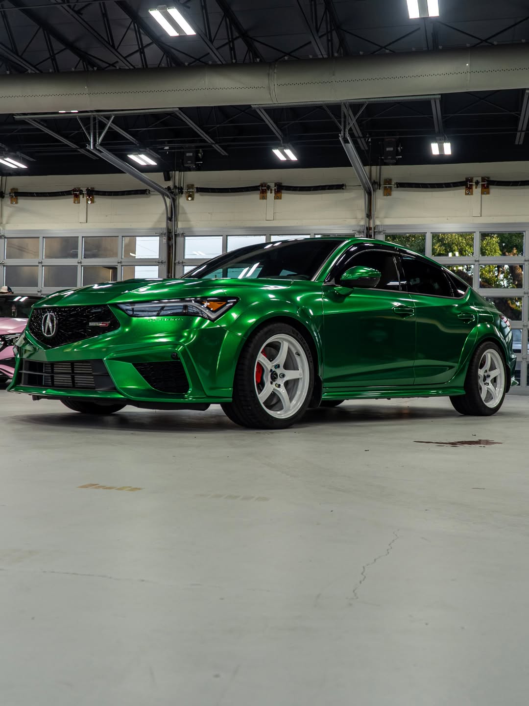 Green metallic wrapped Acura Integra front three quarter view in the FILMHAUS studio