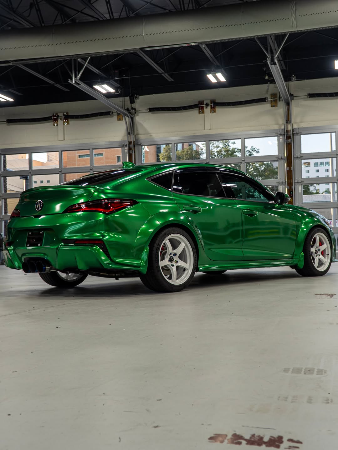 Green metallic Acura Integra with tinted side and rear glass in the FILMHAUS studio