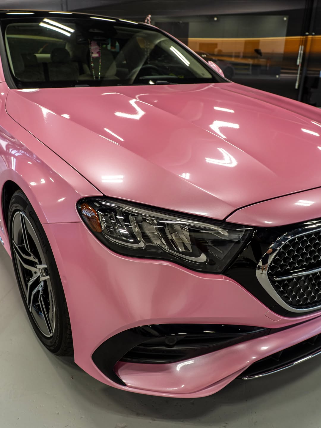 Close up of a gloss pink wrapped Mercedes hood and headlight
